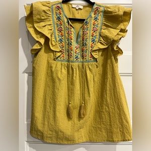 Womens mustard colored short sleeve embroidered blouse.